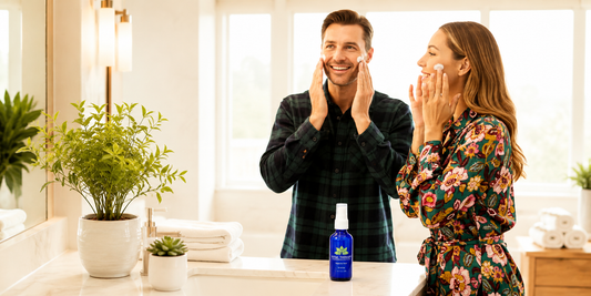 Vital Therapy men's essential skincare set with cobalt blue bottles against tropical greenery